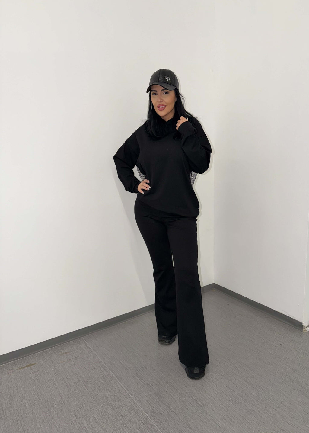 Model poartă pantaloni pentru trening "FLARE" de la SIA, cu talie înaltă și croi evazat, pentru un look modern. Cuvânt cheie: pantaloni.