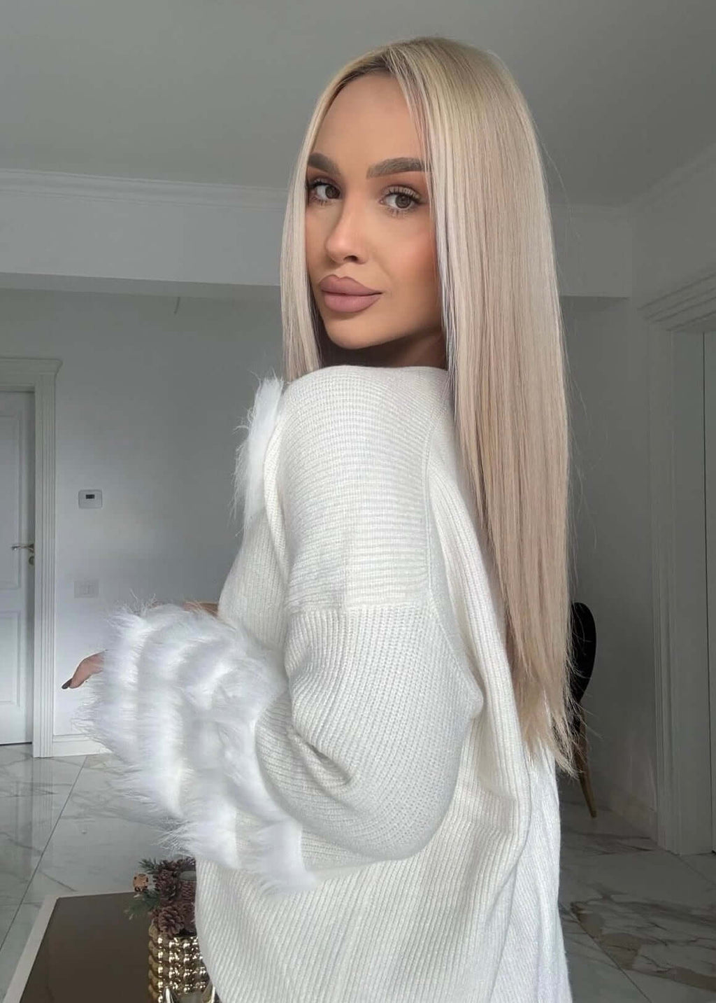 Pulover oversized alb SIA Feather Luxe cu pene la mâneci, purtat în interior, stil casual elegant